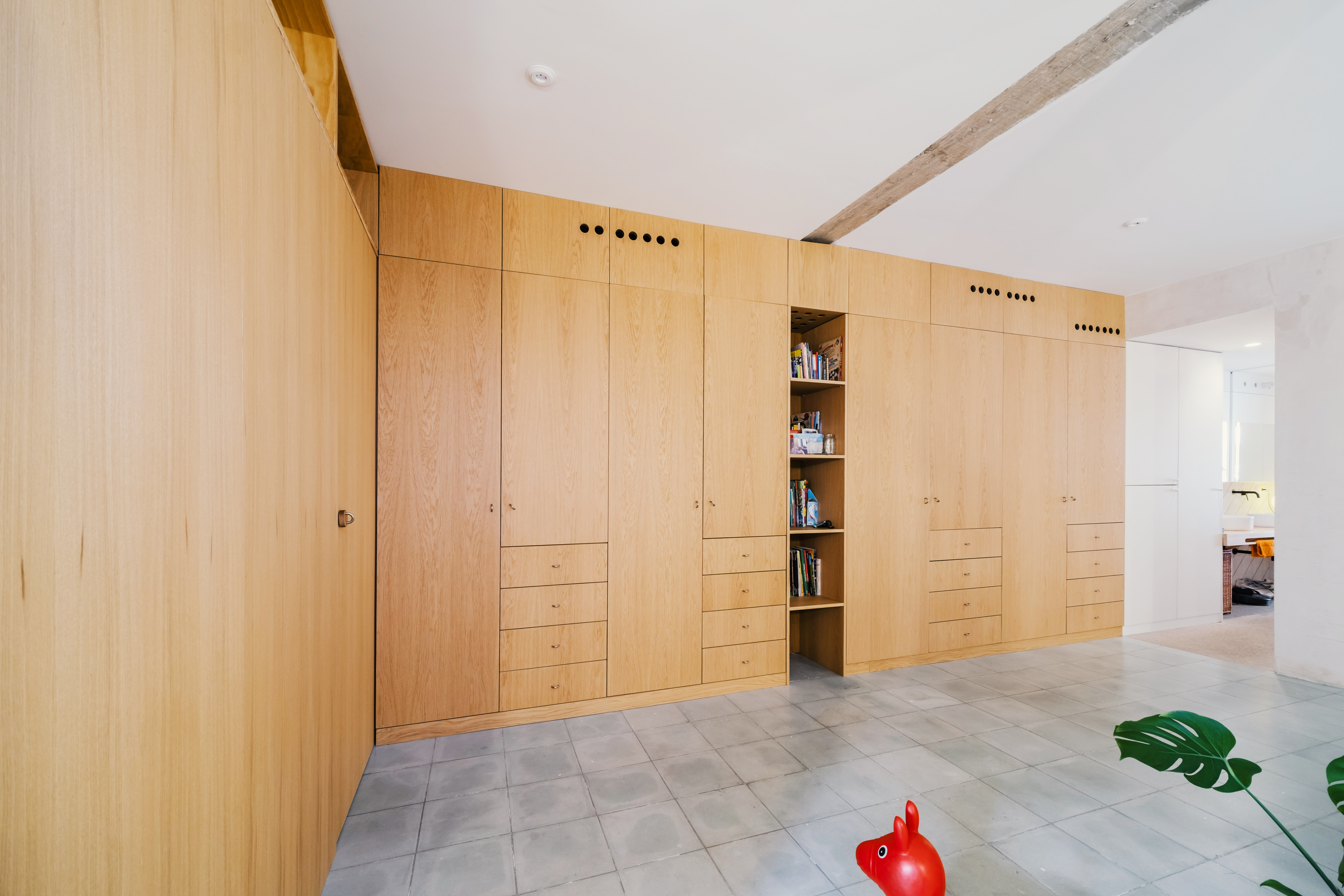 Mueble de madera diseñado a medida que organiza el espacio de la vivienda.