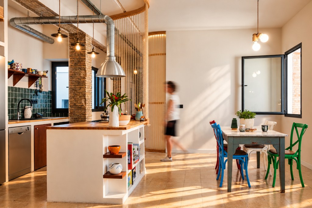 Interior de una vivienda reformada por GYRA Architects con mobiliario de madera a medida y divisiones de cuerda.